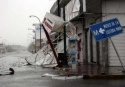 Debris lies at a flooded street after Hurricane Dean hits Chetumal in the state of Quintana Roo August 21, 2007. Hurricane Dean smashed into Mexico\'s Caribbean coast on Tuesday, its ferocious winds battering beach resorts where tens of thousands of tourists and residents huddled in shelters. REUTERS/Henry Romero (MEXICO) 